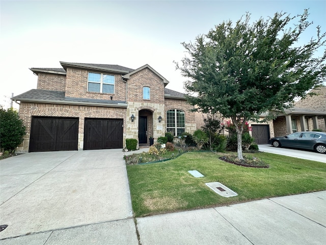7239 Clementine Dr, Irving, TX 75063 - french country home featuring a front lawn, concrete driveway, brick siding, a garage, and roof with shingles