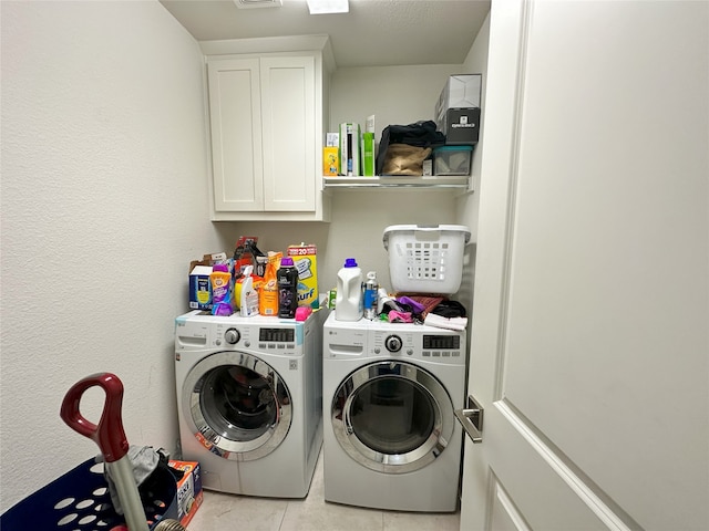 7239 Clementine Dr, Irving, TX 75063 - clothes washing area with washing machine and dryer, cabinet space, and light tile patterned floors