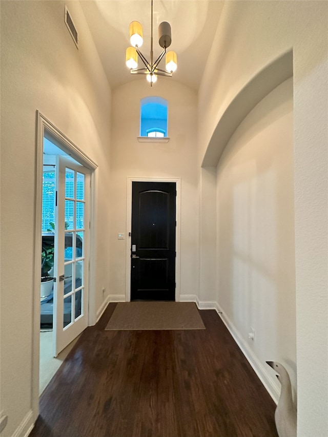 7239 Clementine Dr, Irving, TX 75063 - foyer featuring dark wood finished floors, lofted ceiling, a chandelier, and baseboards