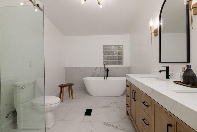 24882 US Highway 377, Whitesboro, TX 76273 - full bathroom featuring marble look tiles, a soaking tub, toilet, double vanity, and a wainscoted wall
