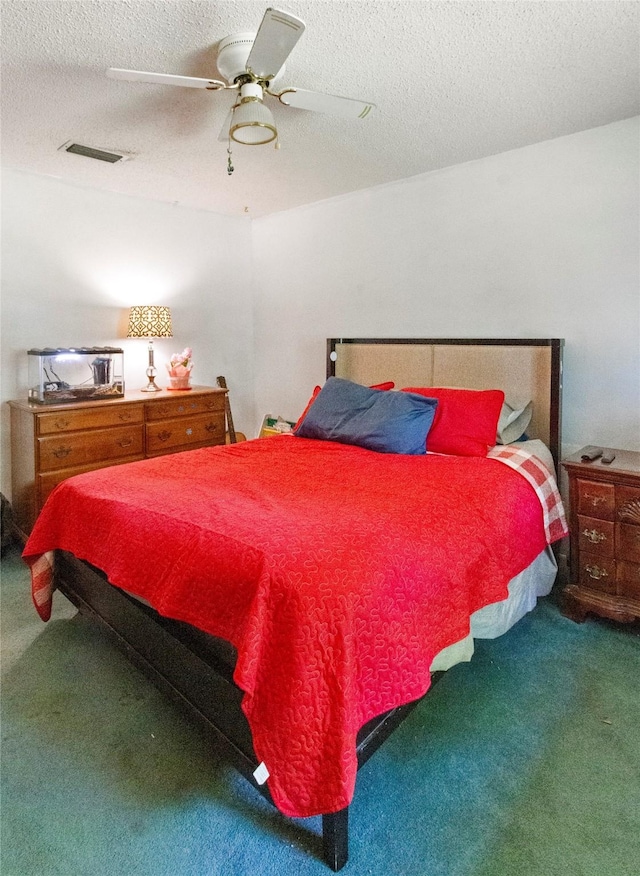 carpeted bedroom with a textured ceiling and a ceiling fan