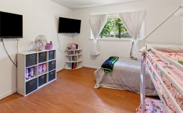 bedroom featuring light wood-style flooring and baseboards
