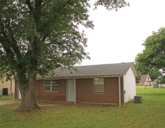 1815 Pelican W, Pelican Bay, TX 76020 - view of front of property featuring central AC unit, brick siding, a front yard, a shingled roof, and concrete driveway