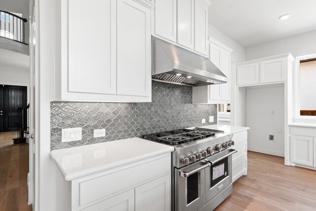 1758 Cousins Trl, Frisco, TX 75034 - kitchen featuring range with two ovens, under cabinet range hood, light wood-type flooring, and white cabinets