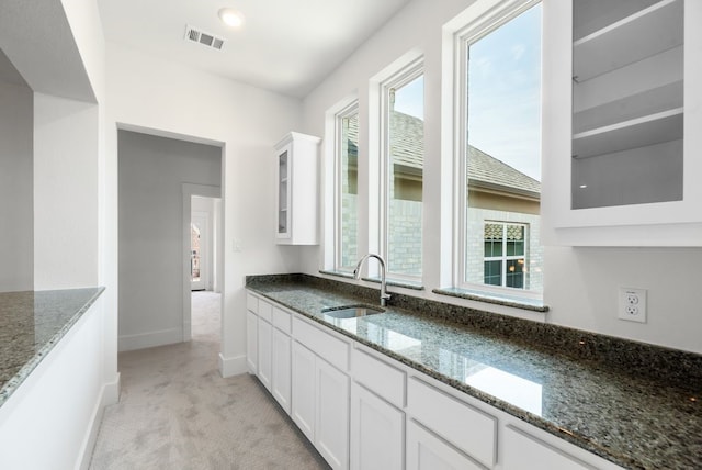 1758 Cousins Trl, Frisco, TX 75034 - kitchen with a sink, light carpet, glass insert cabinets, white cabinets, and dark stone countertops