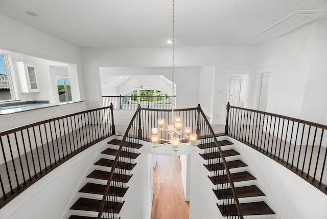 1758 Cousins Trl, Frisco, TX 75034 - stairway featuring attic access, a chandelier, and wood finished floors