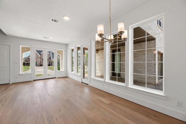 1758 Cousins Trl, Frisco, TX 75034 - unfurnished sunroom featuring french doors, a chandelier, and plenty of natural light