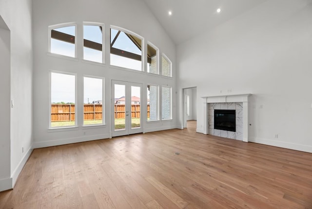 1758 Cousins Trl, Frisco, TX 75034 - unfurnished living room featuring high vaulted ceiling, light wood-style flooring, baseboards, french doors, and recessed lighting