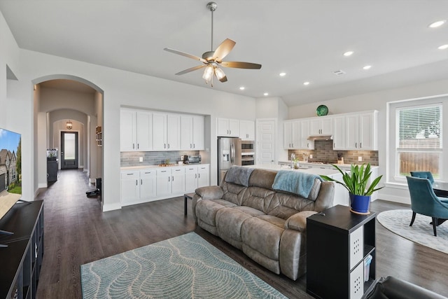 4121 Crossroads Ct, Oak Point, TX 75068 - living room featuring a ceiling fan, arched walkways, dark wood-type flooring, and recessed lighting