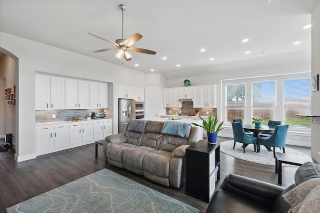 4121 Crossroads Ct, Oak Point, TX 75068 - living room with dark wood finished floors, ceiling fan, arched walkways, and recessed lighting