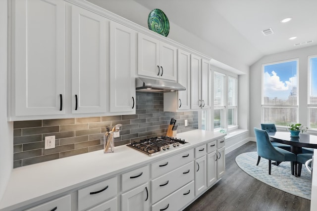 4121 Crossroads Ct, Oak Point, TX 75068 - kitchen with under cabinet range hood, stainless steel gas cooktop, white cabinets, dark wood-style flooring, and lofted ceiling