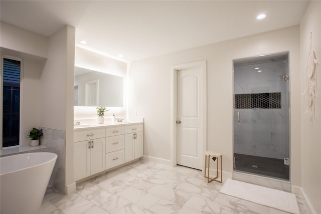509 Farine Dr, Irving, TX 75062 - full bath with marble finish flooring, a shower stall, a freestanding bath, double vanity, and recessed lighting