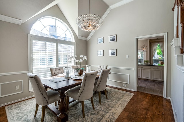 1433 Rogers Ct, Allen, TX 75013 - dining area with a chandelier, dark wood-type flooring, crown molding, high vaulted ceiling, and wainscoting