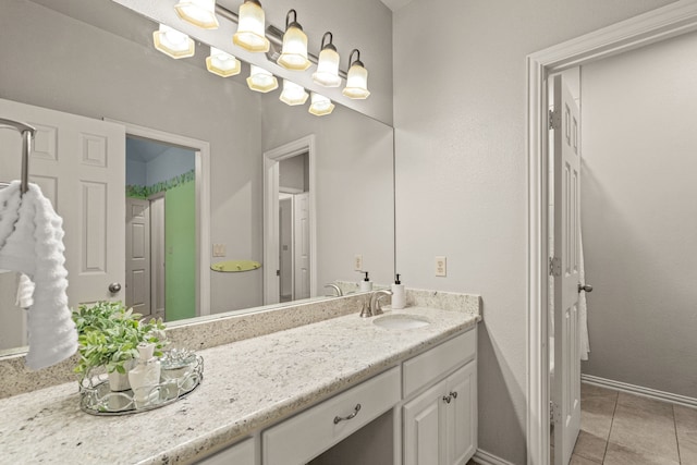 bathroom featuring tile patterned floors, vanity, and baseboards