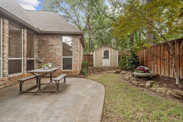 fenced backyard featuring a patio area, a shed, an outbuilding, and outdoor dining space