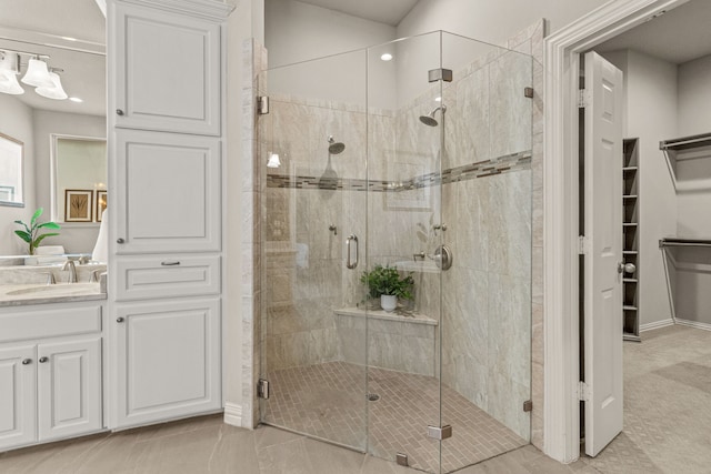 full bathroom with a shower stall, a spacious closet, vanity, recessed lighting, and tile patterned floors