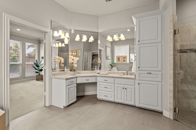 full bath with a shower stall, a chandelier, and vanity