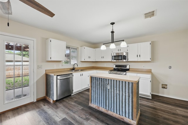 2324 Southway, Denton, TX 76207 - kitchen featuring appliances with stainless steel finishes, a sink, light countertops, and white cabinetry