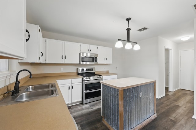 2324 Southway, Denton, TX 76207 - kitchen with stainless steel appliances, a sink, dark wood finished floors, white cabinetry, and light countertops