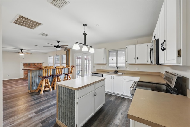 2324 Southway, Denton, TX 76207 - kitchen with stainless steel appliances, french doors, a sink, white cabinetry, and dark wood-type flooring