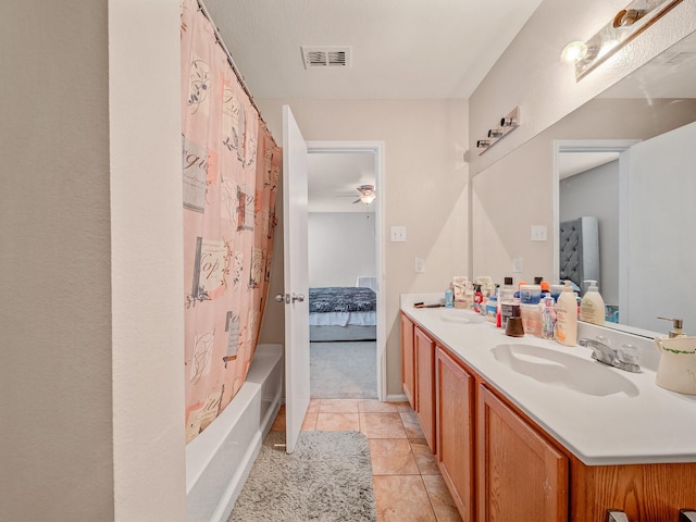 9228 Cheswick Dr, Fort Worth, TX 76123 - ensuite bathroom featuring double vanity, a ceiling fan, tile patterned floors, and shower / bathtub combination with curtain