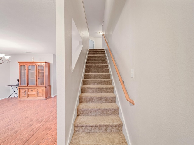 9228 Cheswick Dr, Fort Worth, TX 76123 - staircase featuring wood finished floors, baseboards, and a chandelier