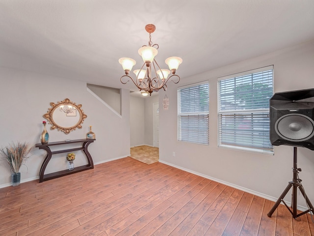 9228 Cheswick Dr, Fort Worth, TX 76123 - unfurnished dining area with a chandelier, wood finished floors, and baseboards