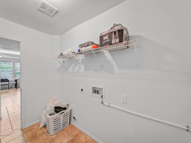 9228 Cheswick Dr, Fort Worth, TX 76123 - washroom featuring washer hookup, hookup for an electric dryer, light tile patterned floors, and baseboards