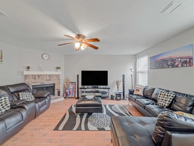 9228 Cheswick Dr, Fort Worth, TX 76123 - living area with ceiling fan, light wood-style flooring, and a brick fireplace