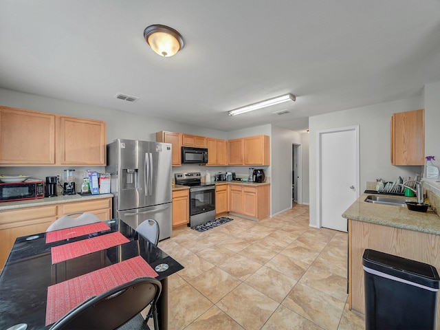 9228 Cheswick Dr, Fort Worth, TX 76123 - kitchen with appliances with stainless steel finishes, a sink, light brown cabinetry, and light tile patterned flooring