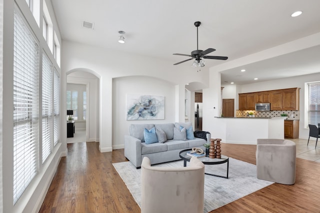11393 Classic Ln, Frisco, TX 75033 - living room featuring arched walkways, healthy amount of natural light, ceiling fan, and recessed lighting