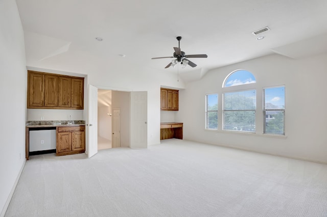 11393 Classic Ln, Frisco, TX 75033 - unfurnished living room featuring light colored carpet, ceiling fan, lofted ceiling, bar with sink, and baseboards