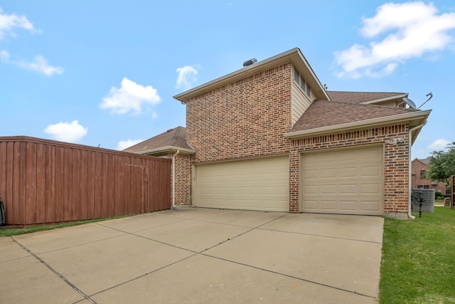 11393 Classic Ln, Frisco, TX 75033 - view of home's exterior with brick siding, concrete driveway, roof with shingles, a garage, and central AC