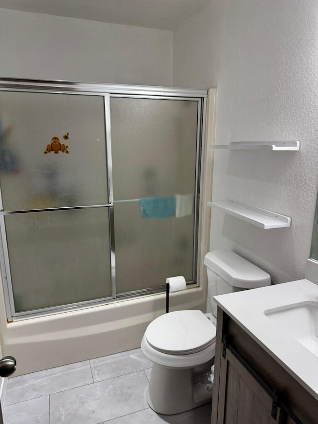 419 Travis St, Ranger, TX 76470 - full bathroom with a textured wall, vanity, toilet, shower / bath combination with glass door, and tile patterned floors