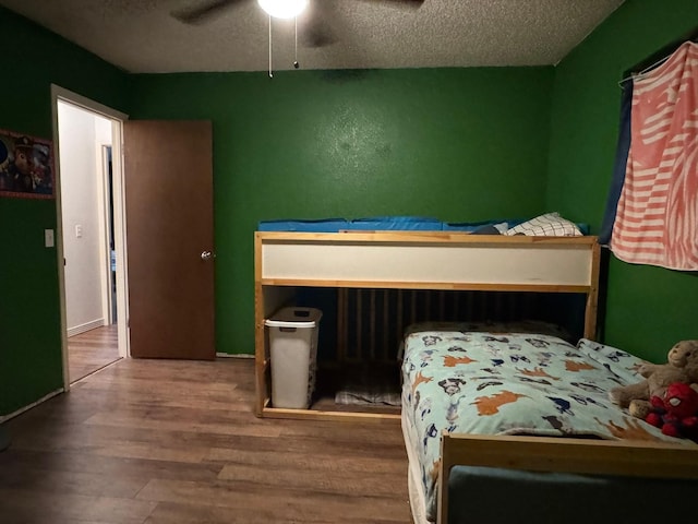 419 Travis St, Ranger, TX 76470 - bedroom featuring wood finished floors, a textured ceiling, and ceiling fan