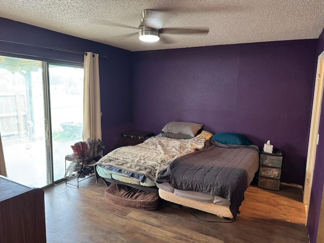 419 Travis St, Ranger, TX 76470 - bedroom featuring wood finished floors, a textured ceiling, access to outside, and a ceiling fan