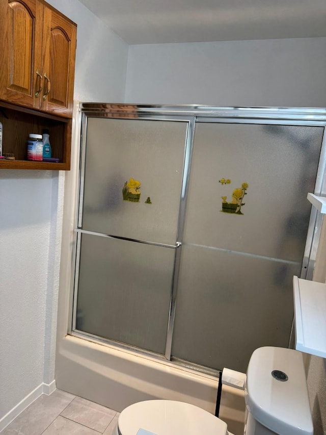 419 Travis St, Ranger, TX 76470 - full bathroom with toilet, tile patterned flooring, bath / shower combo with glass door, and baseboards