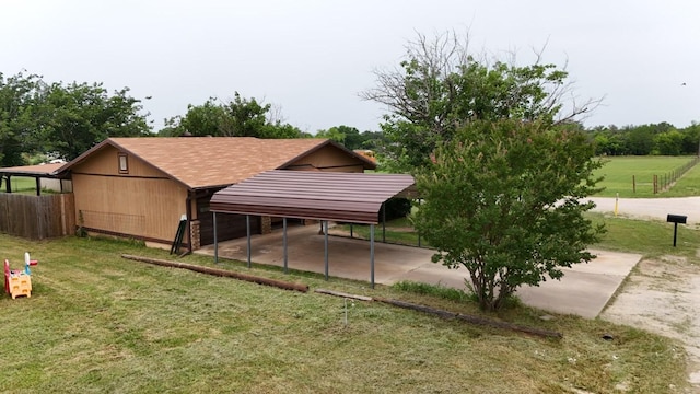 419 Travis St, Ranger, TX 76470 - rear view of house featuring a detached carport