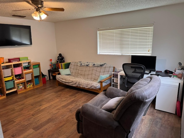 419 Travis St, Ranger, TX 76470 - living area featuring wood finished floors, a ceiling fan, and a textured ceiling