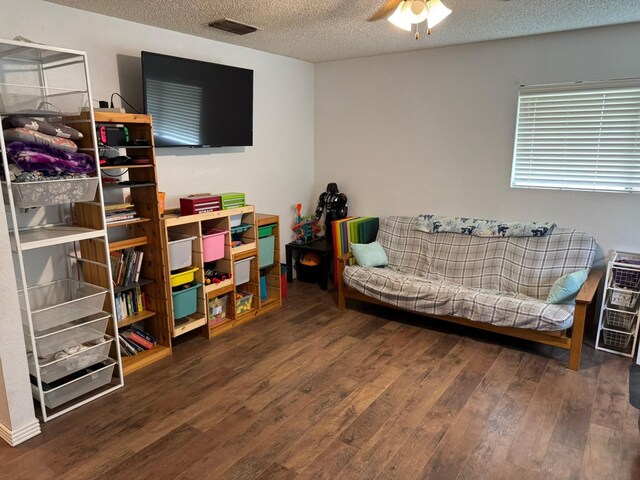419 Travis St, Ranger, TX 76470 - sitting room with wood finished floors, a textured ceiling, and ceiling fan