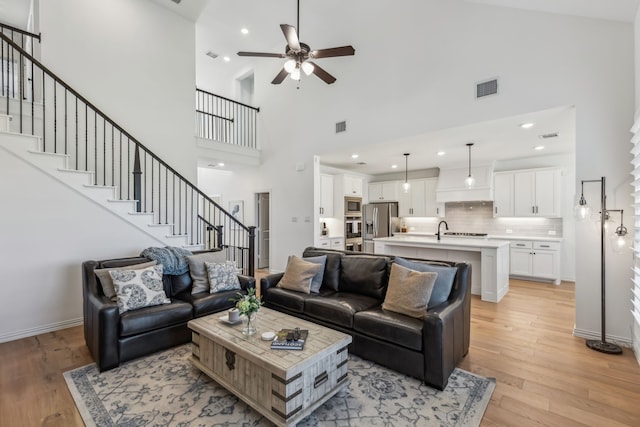 2171 Cloverfern Way, Haslet, TX 76052 - living area featuring high vaulted ceiling, ceiling fan, stairway, light wood-style floors, and recessed lighting