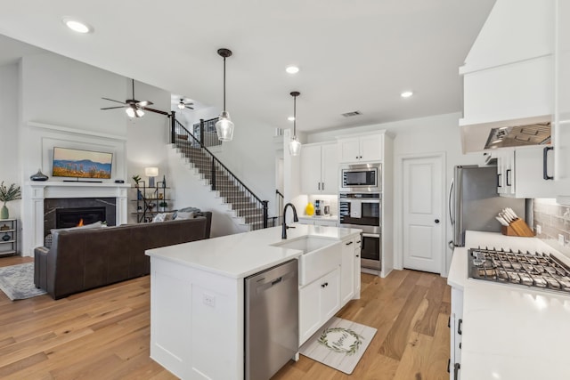 2171 Cloverfern Way, Haslet, TX 76052 - kitchen featuring stainless steel appliances, open floor plan, light countertops, light wood finished floors, and recessed lighting