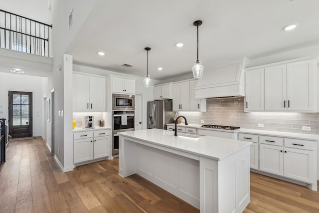 2171 Cloverfern Way, Haslet, TX 76052 - kitchen featuring appliances with stainless steel finishes, a sink, custom range hood, light countertops, and white cabinets
