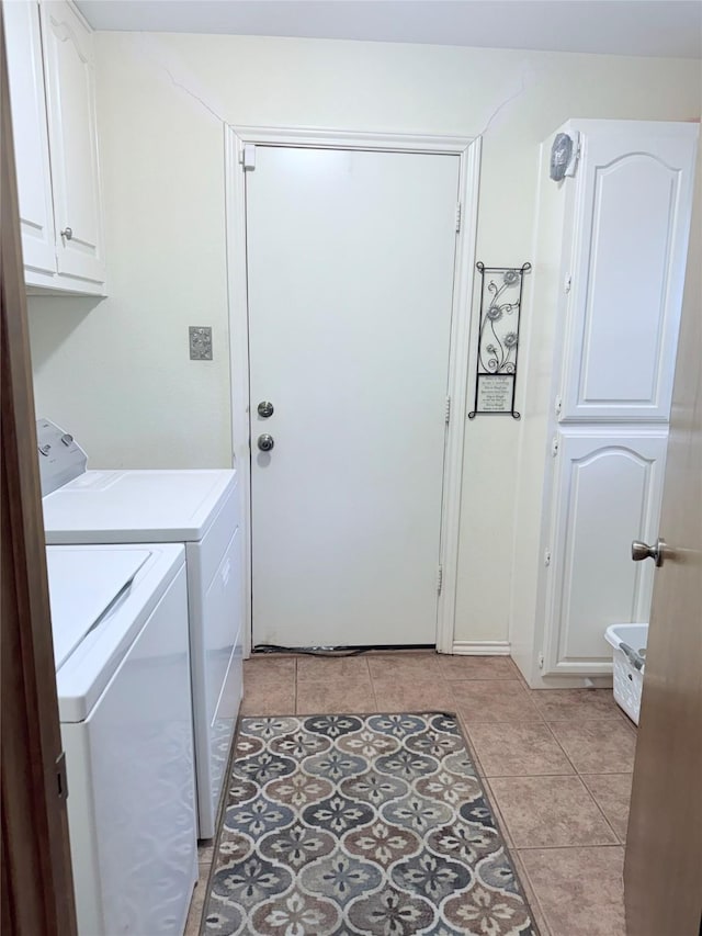 850 Oakbluff Dr, Lancaster, TX 75146 - washroom featuring cabinet space, washer and clothes dryer, and light tile patterned flooring