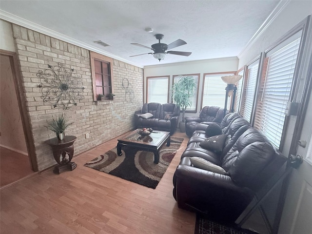 850 Oakbluff Dr, Lancaster, TX 75146 - living room with brick wall, ceiling fan, wood finished floors, crown molding, and a textured ceiling