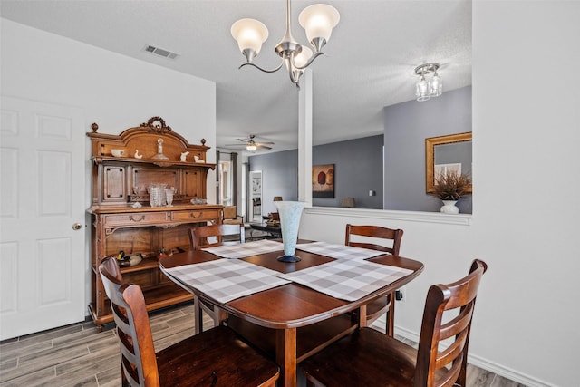6706 Trumpet Dr, Rowlett, TX 75089 - dining space with light wood finished floors, a ceiling fan, a chandelier, and baseboards