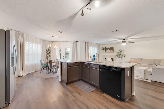 7536 Brentwood Stair Rd, Fort Worth, TX 76112 - kitchen with black dishwasher, open floor plan, stainless steel fridge, a chandelier, and wood finished floors