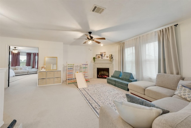 7536 Brentwood Stair Rd, Fort Worth, TX 76112 - carpeted living area with ceiling fan and a warm lit fireplace