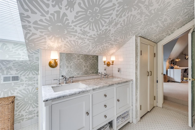 3437 Purdue St, University Park, TX 75225 - bathroom with wallpapered walls, double vanity, and lofted ceiling
