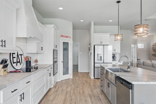 115 Lavender Ln, Springtown, TX 76082 - kitchen with appliances with stainless steel finishes, a sink, premium range hood, white cabinetry, and backsplash